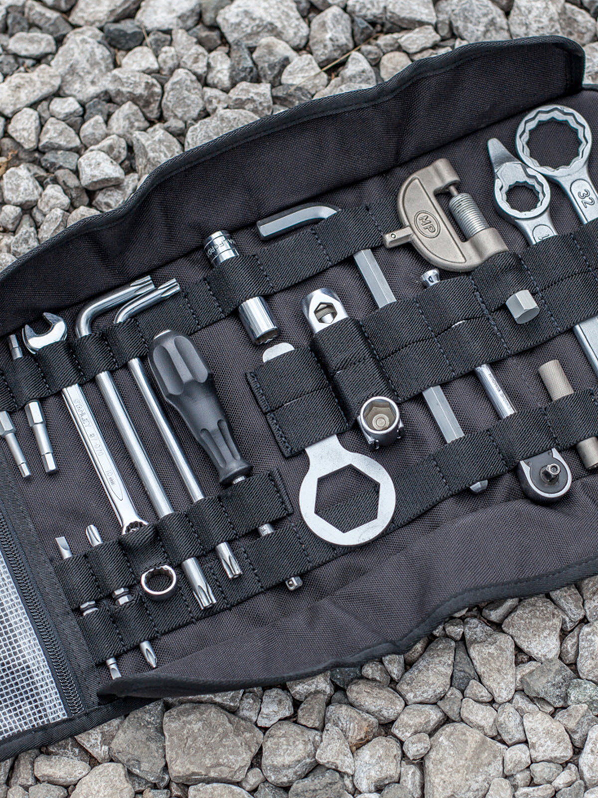 Kriega Tool Roll with tools on stoney ground